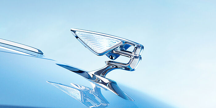 JCT600 Service Teeside Bentley Flying Spur Azure sedan bonnet close up in Light Windsor Blue paint with Illuminated Flying B mascot