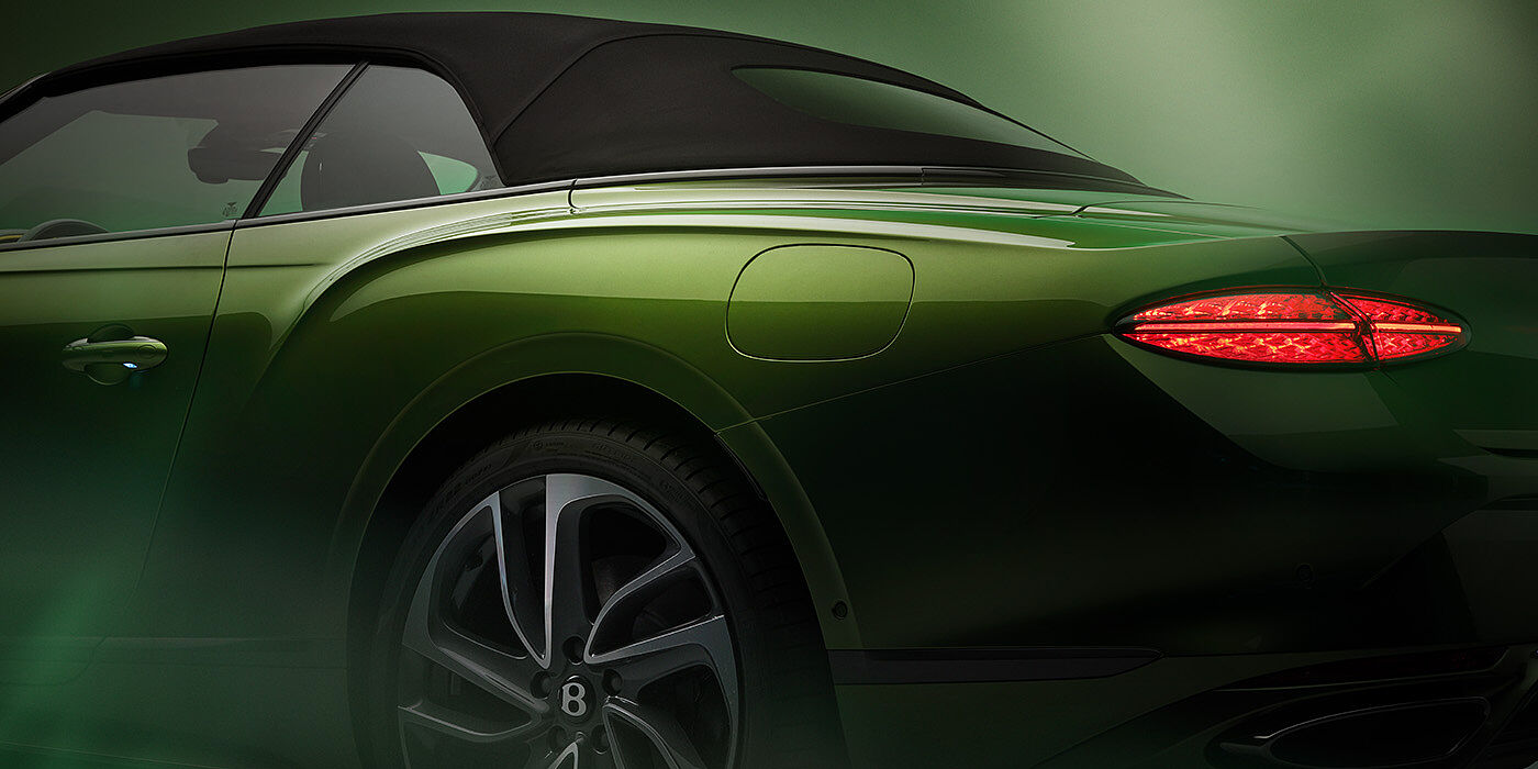 JCT600 Service Teeside Bentley New Continental GTC Speed rear haunch and tail lamp in Tourmaline Green paint and dark tint brightware with black hood up and illuminated head lamps