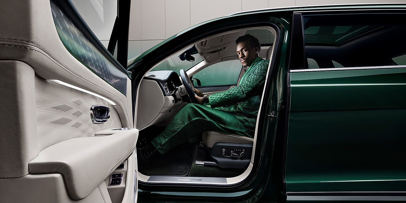 JCT600 Service Teeside Wisdom K seated in Bentley Bentayga Extended Wheelbase SUV in Light Emerald green paint with door open