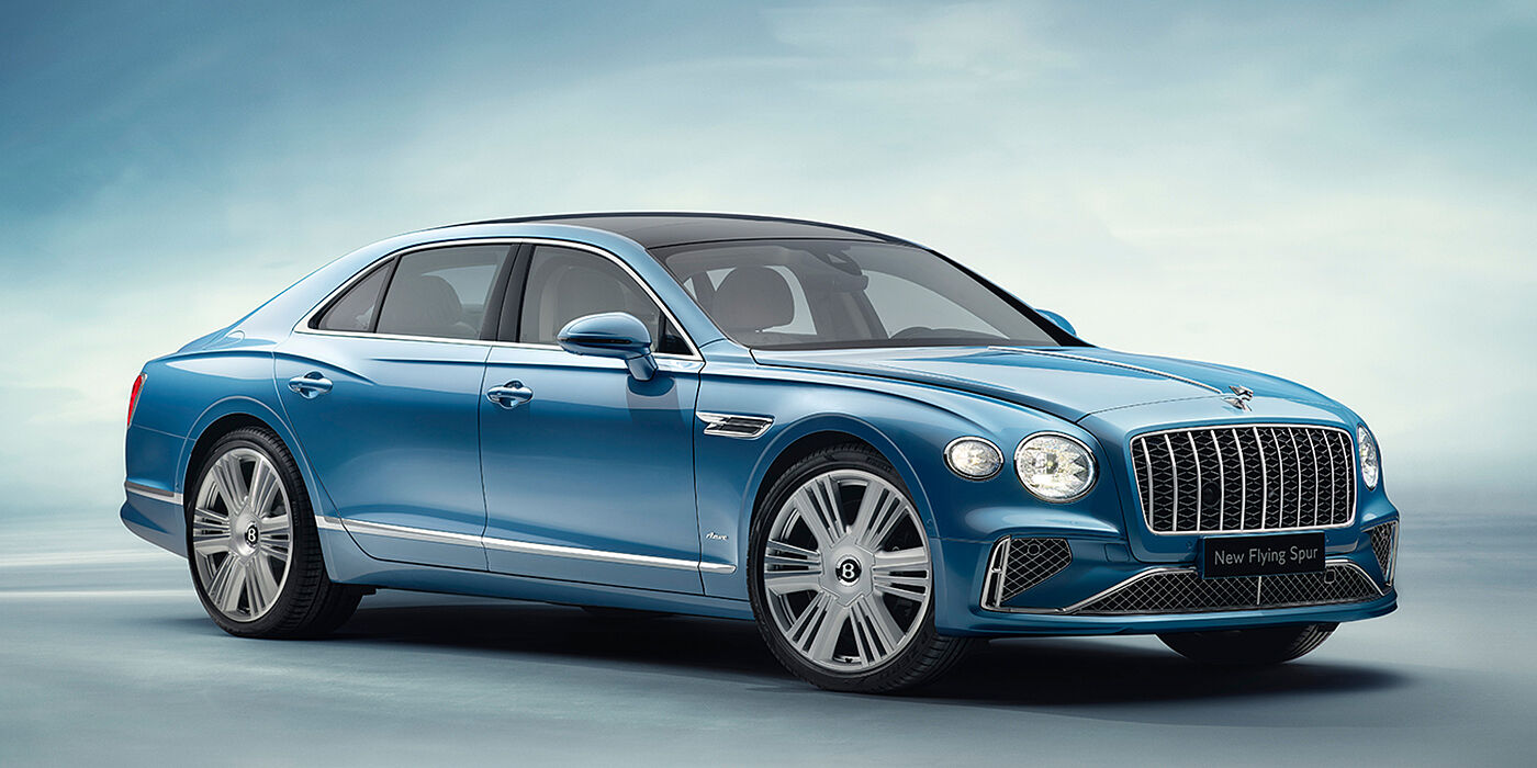 JCT600 Service Teeside New Bentley Flying Spur Azure sedan front view in Light windsor blue by Mulliner paint with 22 inch Azure wheels and chrome exterior details