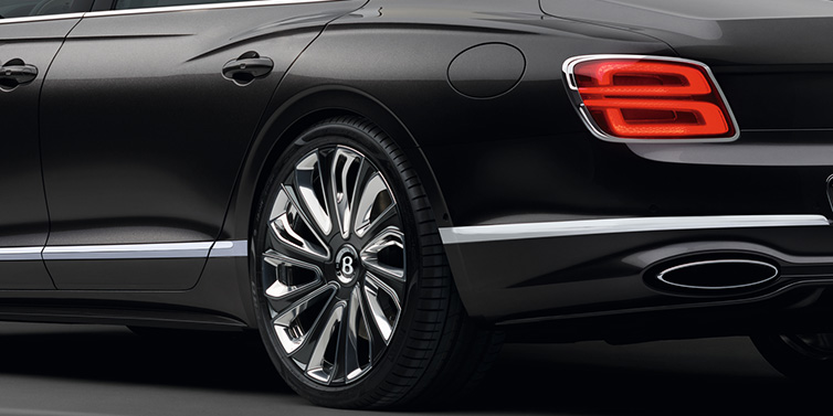 JCT600 Service Teeside Bentley Flying Spur Mulliner sedan rear side exterior detail in Magnetic paint and 22 inch Mulliner painted and polished wheel