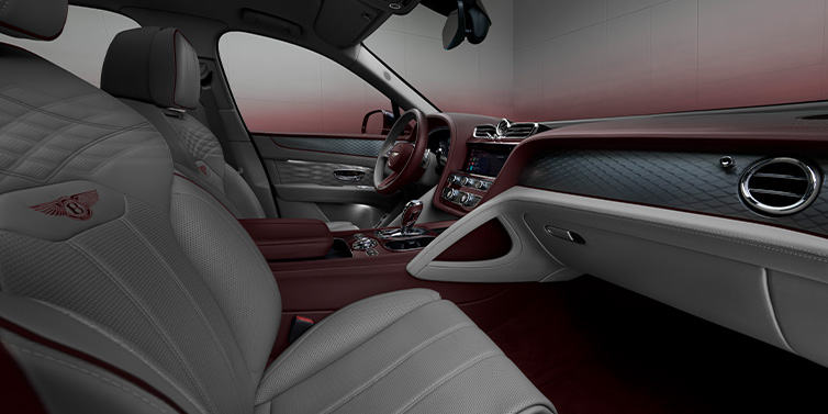 JCT600 Service Teeside Bentley Bentayga Atelier Edition SUV front interior in Gravity Gray and Cricket Ball red hides with Dark Tint Diamond Brushed Aluminium veneer