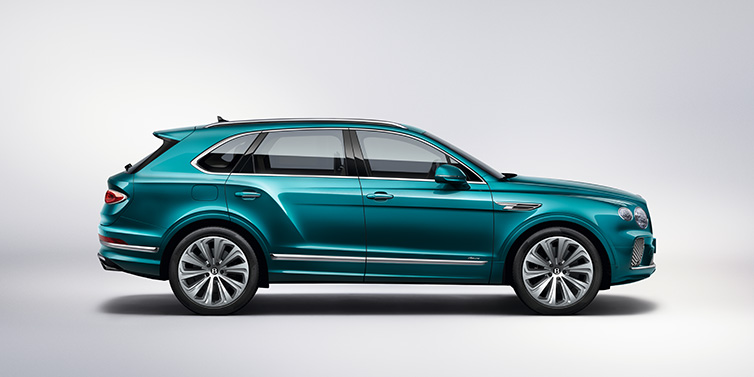 JCT600 Service Teeside Bentley Bentayga Azure SUV in profile in Topaz blue paint featuring 22 inch 10 spoke directional wheels against a white background