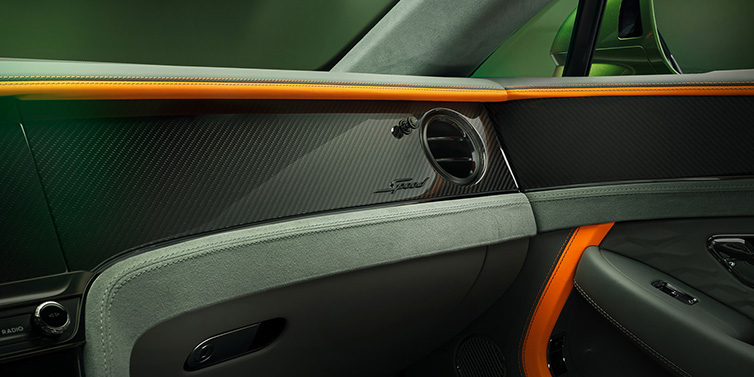 JCT600 Service Teeside Bentley Continental GT Speed coupe front interior dash detail with high gloss carbon fibre veneer surrounded by Mandarin by Mulliner and Gravity Grey hides