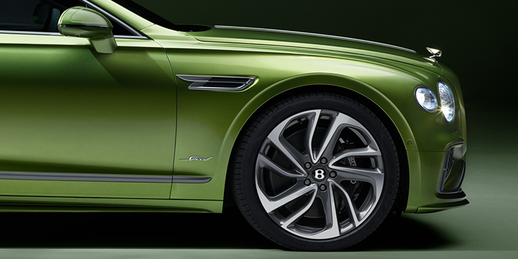 JCT600 Service Teeside Bentley Flying Spur Speed sedan exterior close up in Tourmaline Green paint with chrome B wing vent, chrome Speed badge and 22 inch ten swept spoke wheel