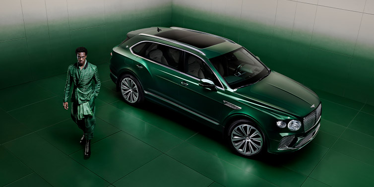 JCT600 Service Teeside Wisdom K standing next to Bentley Bentayga Extended Wheelbase SUV in Light Emerald green paint seen from overhead