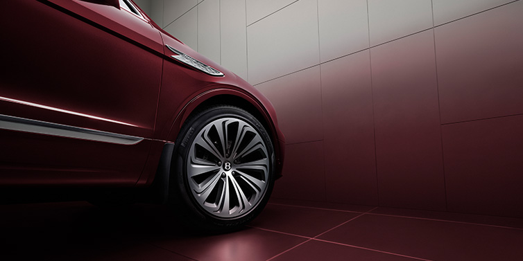 JCT600 Service Teeside Bentley Bentayga Atelier Edition SUV in Rubino Red paint front side detail with 22 inch 10 spoke wheel