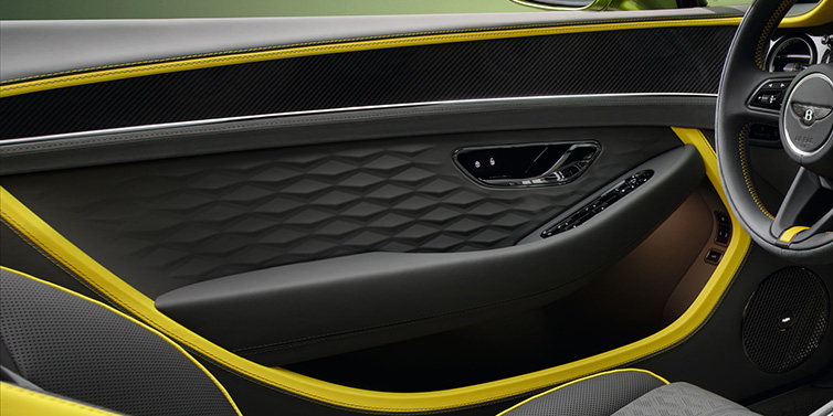 JCT600 Service Teeside Bentley Continental GTC Speed convertible interior door details featuring Gravity Grey and Cyber Yellow by Mulliner hides and high gloss carbon fibre veneer