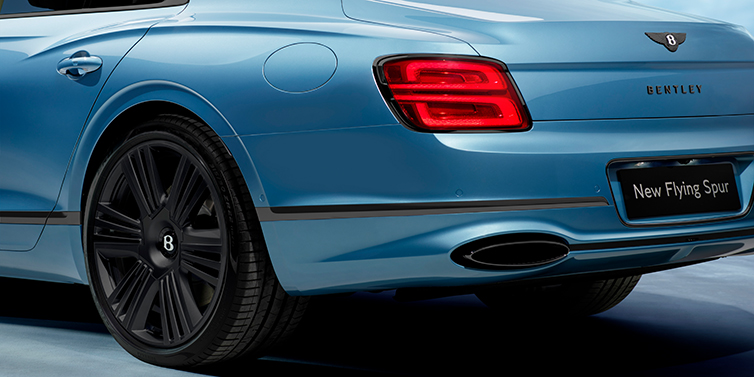 JCT600 Service Teeside New Bentley Flying Spur Azure sedan in Light windsor blue by Mulliner paint and Black Specification, showing 22 inch Black Azure wheel, black exhaust pipes and exterior features