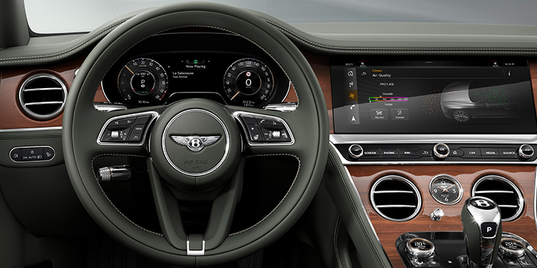 JCT600 Service Teeside New Bentley Continental GT coupe steering wheel and front cabin view in Cumbrian Green hide and Crown Cut walnut veneer
