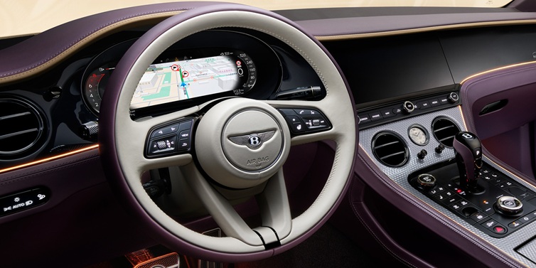 JCT600 Service Teeside Bentley Continental GT Mulliner coupe front interior showing steering wheel and drivers screens surrounded by Linen and Damson hides and Grand Black veneer